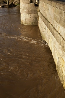 Flood Prints: River flooding with high water levels under bridge