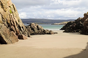 Sandy Prints: Rocks bordering pale beach sands