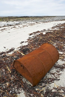 Pollution Prints: Rusty oil drum along high tide mark on deserted beach, Benbecula, Outer Hebrides, Scotland