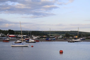 Sailing boats moored in harbour with incoming tide at dawn, Bembridge Harbour, Bembridge, Isle of Wight, England, june