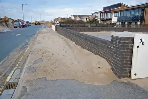 Encroaches Prints: Sand blown from beach and dunes onto road and pavement in seaside resort town