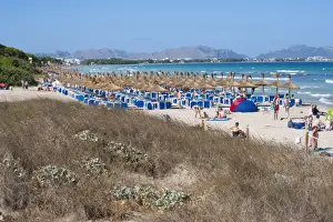 Sandy Prints: Sand dunes behind tourist beach with sunloungers and beach umbrellas