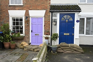 Environmental Prints: Sandbags piled against house doors during river flood