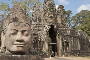 Sculptures Prints: Sculpture of head beside road to gate tower of Khmer temple