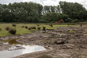 Machinery Prints: A shallow water channel cut in marshland habitat to increase water retention