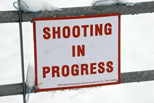Gamebird Prints: Shooting In Progress sign tied to gate in snow