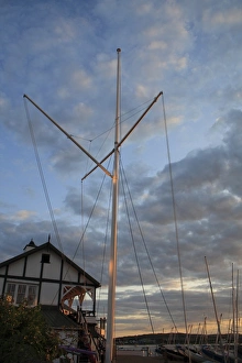 Signal mast at sailing club, in harbour at sunset, Bembridge Harbour, Bembridge, Isle of Wight, England, june