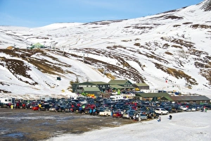 Ski resort carpark, buildings and chairlift in snow, Glenshee Ski Centre, Grampian Mountains, Aberdeenshire, Highlands
