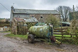 Slurry tanker and farm buildings, Cumbria, England, March