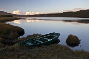Reservoirs Prints: Small rowing boat moored at edge of reservoir