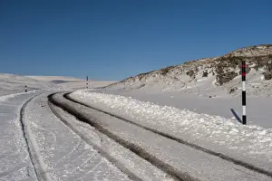 Moorland Prints: Snow covered road on moorland, with poles indicating snow depth levels
