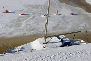 Freeze Prints: Snow covered sailing boat and buoys frozen in ice, Baltic Sea, Sweden, february