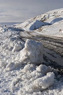 Moorland Prints: Snow and slush covered road on moorland
