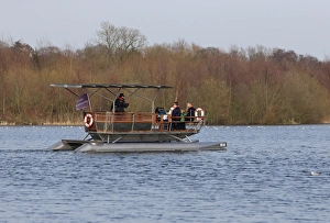 Holidays Prints: Solar-powered electric boat with tourists on river