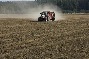 Muck Prints: Steyr tractor with muck spreader, spreading muck on arable field, Sweden, autumn