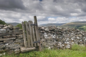 : Stile and gate in drystone wall on public footpath