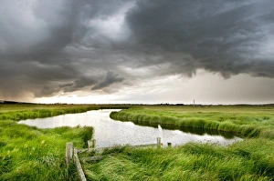 Stormy Prints: Stormclouds over pool in coastal grazing marsh habitat