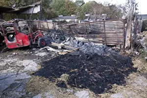 Straw fire in farm yard barn probably coursed by a sugar beat harvesters being parked to closed to the stacked straw
