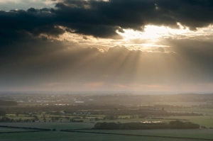 Sunlight Prints: Sunbeams illuminating fields in rural landscape
