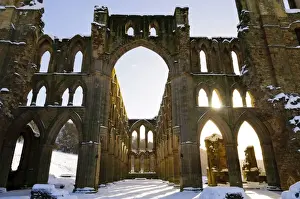 Religions Prints: Sunlight shining through arched windows of ruined cistercian abbey in snow