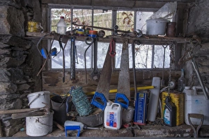 Containers Prints: Tools and containers inside stone barn on farm