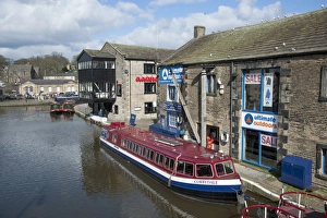Tour Prints: Tour boat and narrowboats moored on canal in town