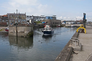 Leaving Prints: Tourist boat leaving harbour for Farne Islands