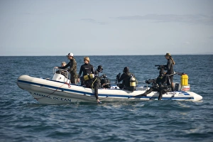 Dive Prints: Tourist divers about to get into water from inflatable boat, offshore Port St