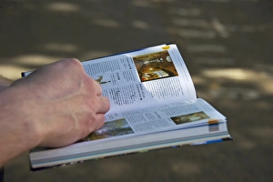 Hand Prints: Tourist with Swedish language travel guidebook, London, England, april