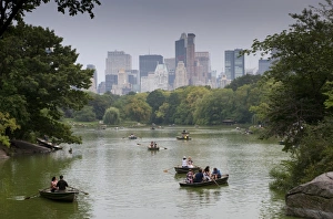 Eastern Seaboard Prints: Tourists in rowing boats on boating lake in city parkland