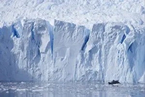 Visit Prints: Tourists on Zodiac inflatable boat in front of coastal glacier terminus
