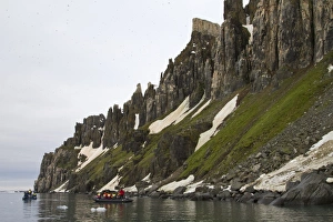 Holidays Prints: Tourists in Zodiac inflatable boats below high cliffs