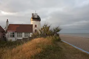 Tower mill converted to residential accommodation beside shingle beach, Fort Green Mill, Aldeburgh, Suffolk, England
