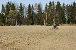 Soil Prints: Tractor pulling harrows, harrowing field, Sweden, spring
