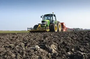 Tractor with seed drill, drilling Westminster spring barley, Pilling, Lancashire, England, march