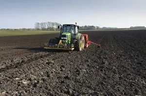 Tractor with seed drill, drilling Westminster spring barley, Pilling, Lancashire, England, march