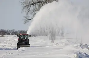 Block Prints: Tractor with snow blower, blowing snow from blocked rural road