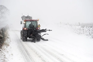 Blizzard Prints: Tractor travelling along rural road during severe snowstorm