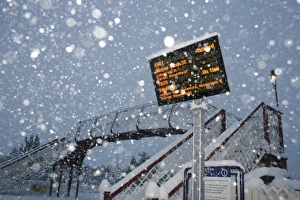 Blizzard Prints: Train delayed sign at railway station during snowstorm