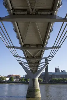 Underneath steel suspension footbridge crossing river, Millennium Bridge, River Thames, London, England, april