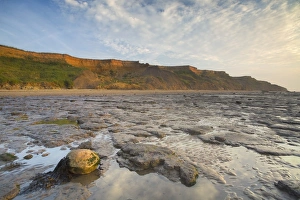 Erodes Prints: View of beach and eroded sea cliffs at sunrise