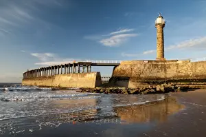 Historic Prints: View of beach and pier with 19th century stone lighthouse in evening sunlight