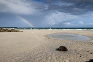 Sandy Prints: View of beach and rainbow forming over sea