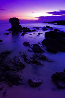 Sun Set Prints: View of beach with rocks silhouetted at sunset, Porth Dafarch, Anglesey, Wales, September