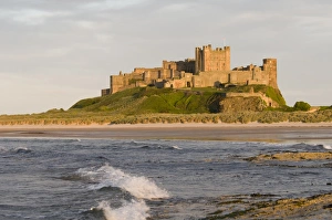 Surf Prints: View across beach and sea towards castle, Bamburgh Castle, Northumberland, England, may