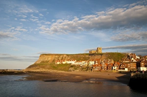Religions Prints: View of beach and seaside town in evening sunlight