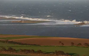 Flood Prints: View of breached shingle seawall and flooded coastal marshland after tidal surge