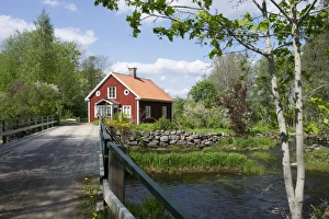 Cottages Prints: View of bridge over river and red house, Uppland, Sweden, may