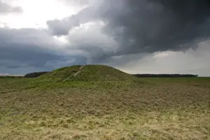 Stormy Prints: View of Bronze Age round barrow and approaching stormclouds