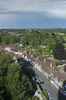 Warwickshire Prints: View from castle overlooking trees and town with old Tudor timber-framed buildings lining street